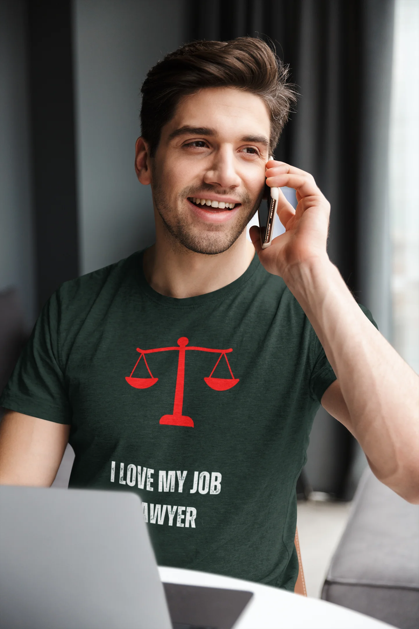 Funny Lawyer Shirt Man wearing a green t-shirt with a lawyer graphic and text, talking on a phone indoors.