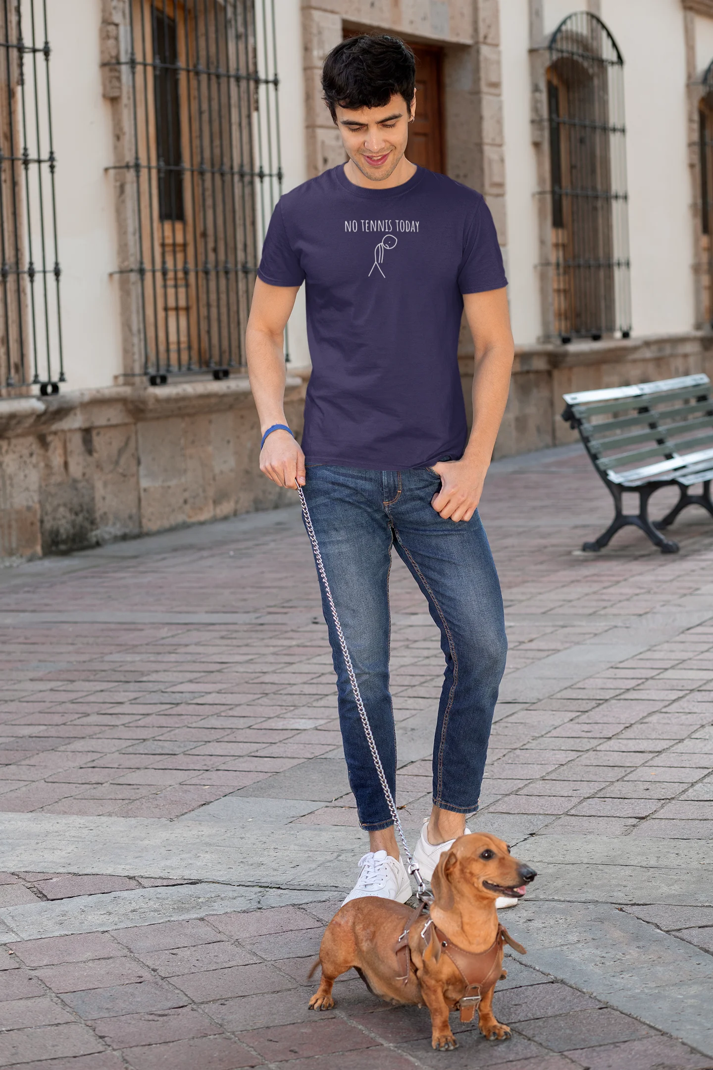 Man walking a dog on a leash in an urban setting