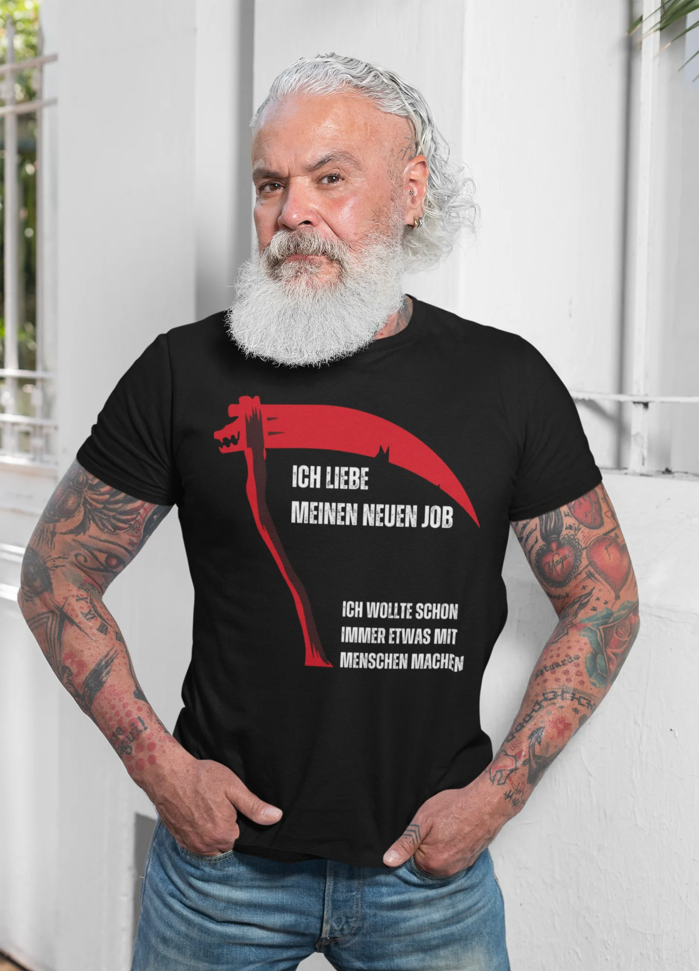Man wearing a black t-shirt with a red graphic and text, standing against a white background.