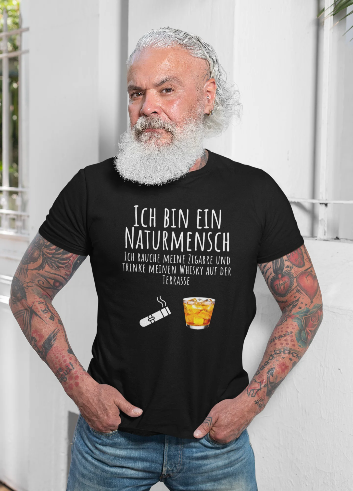 Man wearing a black t-shirt with German text and graphics, standing against a white background.