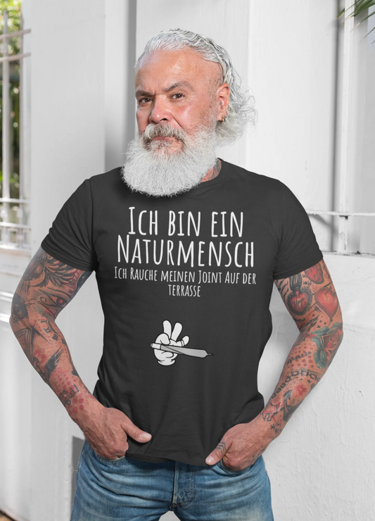 Man wearing a black t-shirt with text and graphics, standing against a white background.