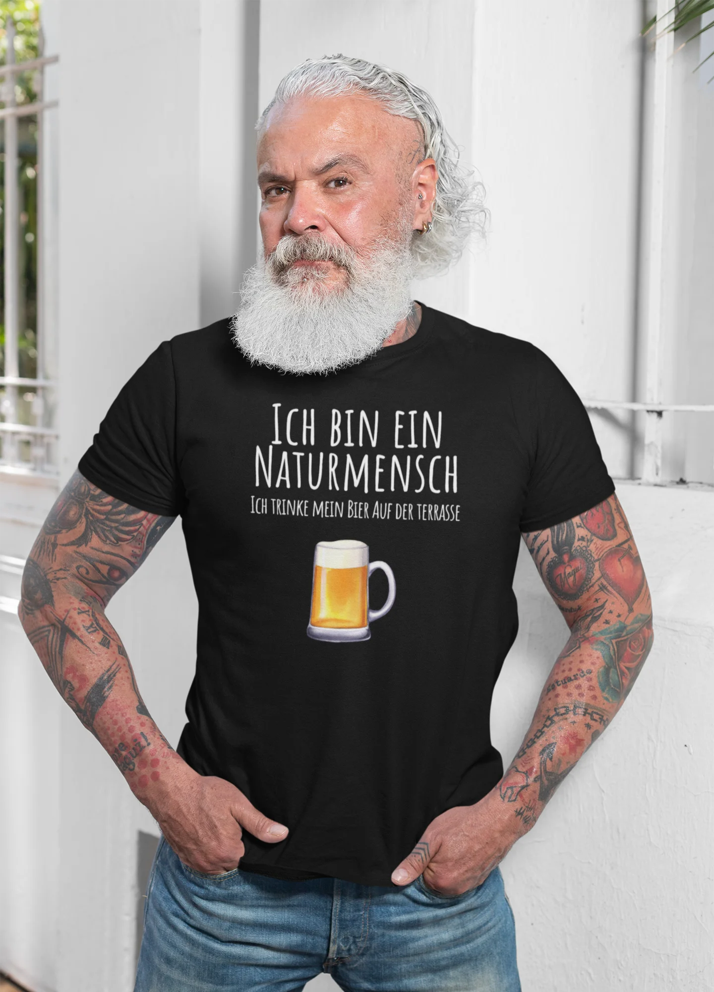 Man wearing a black t-shirt with German text and a beer graphic, standing against a white background.