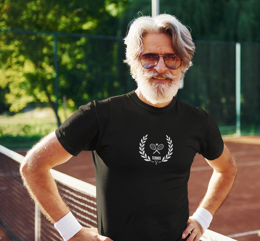 Man wearing a black t-shirt with a tennis-themed design on a tennis court