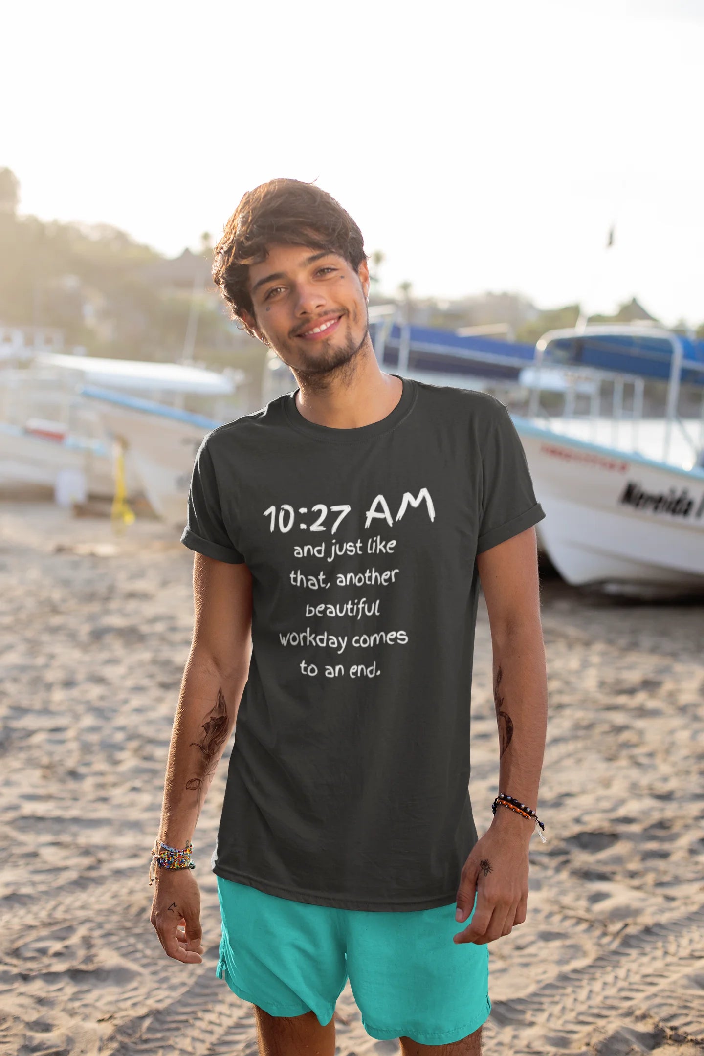 funny office shirt Man wearing a black t-shirt with text on a beach
