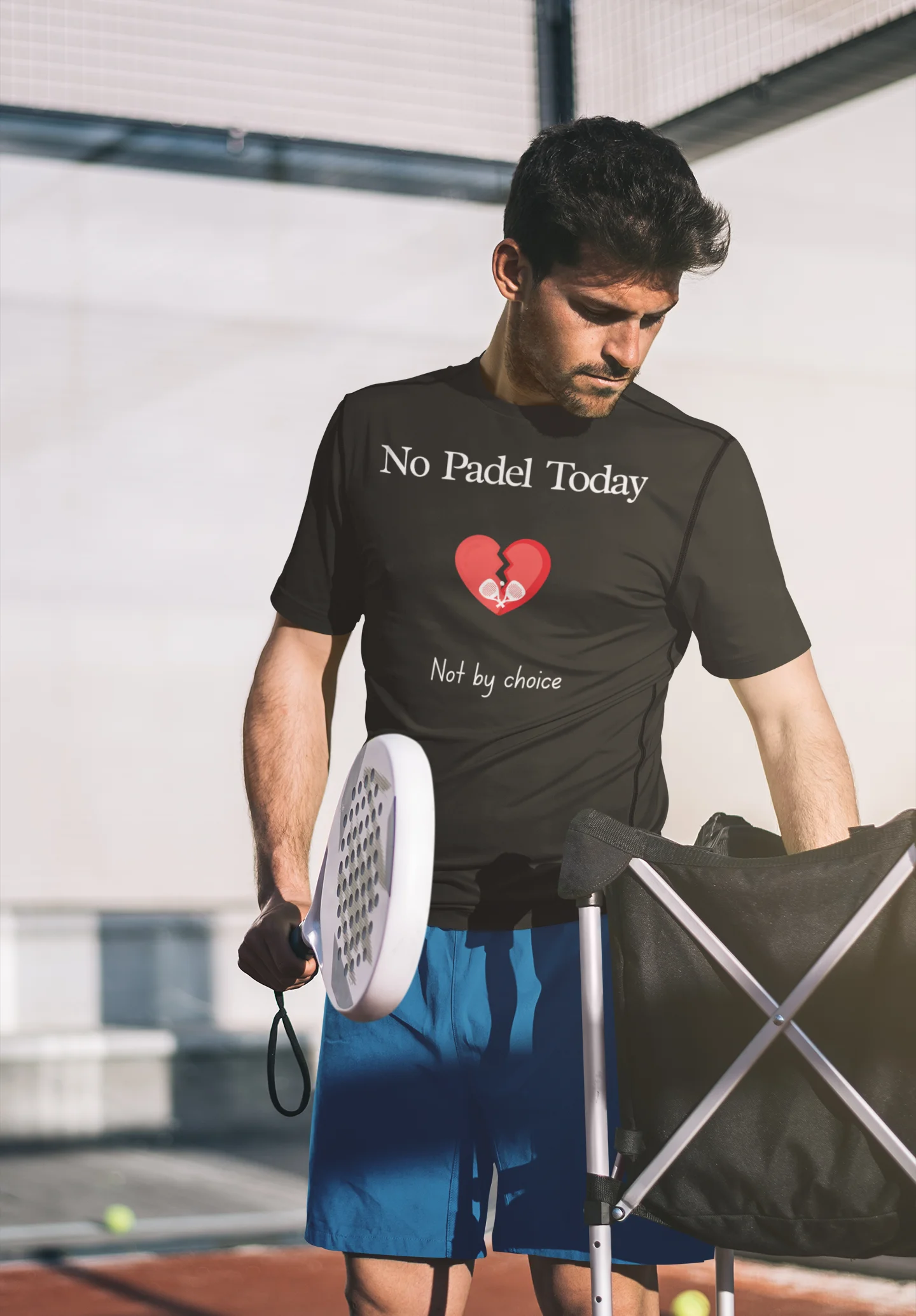 Padel Gift Man wearing a black t-shirt with 'No Padel Today' text, holding a paddle and ball, standing on a tennis court.