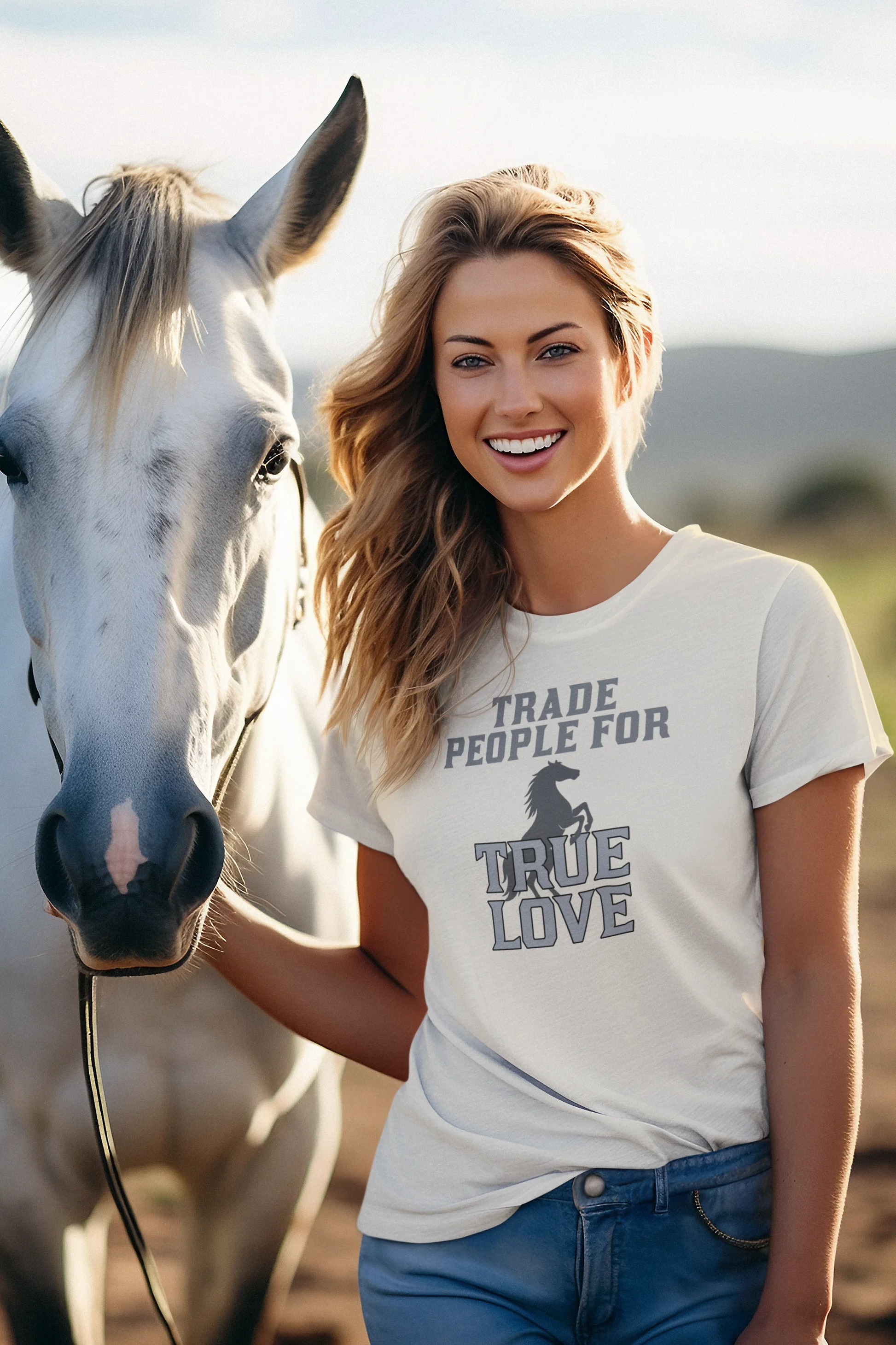 Woman wearing a t-shirt with a horse graphic and text, standing next to a horse.