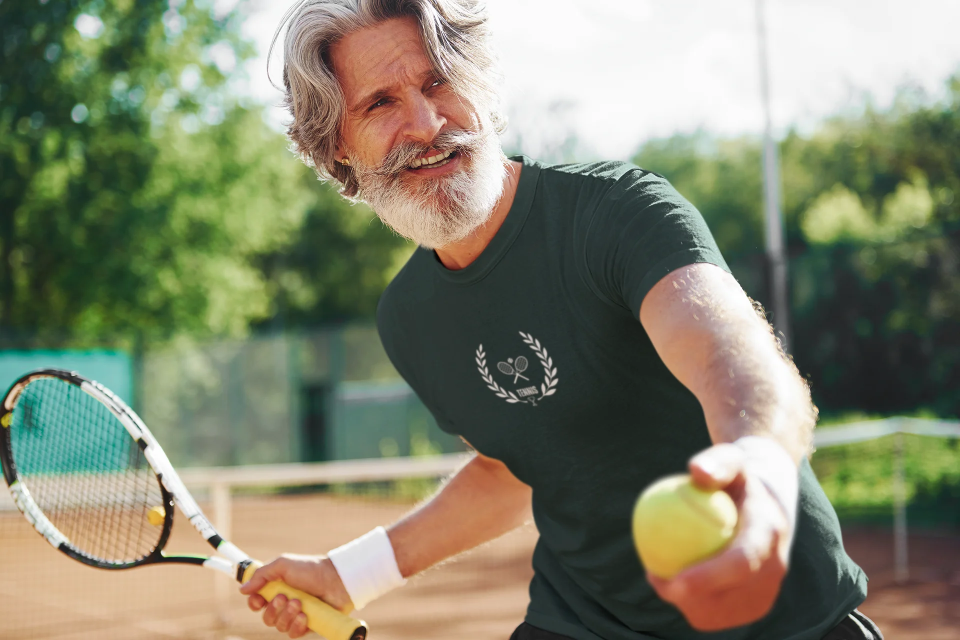 Man on a tennis court holding a racket and ball