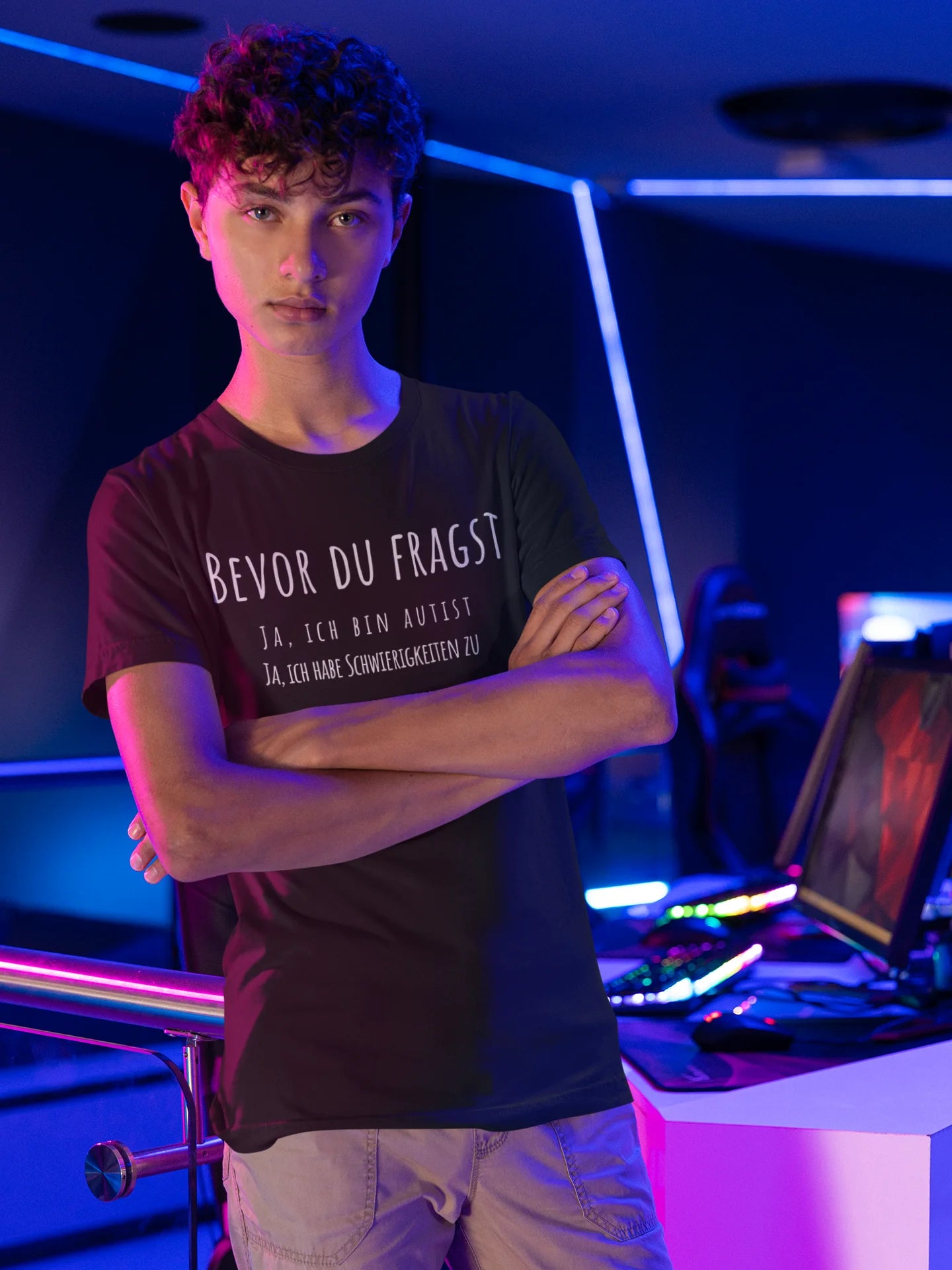 Person wearing a black t-shirt with text in a futuristic setting