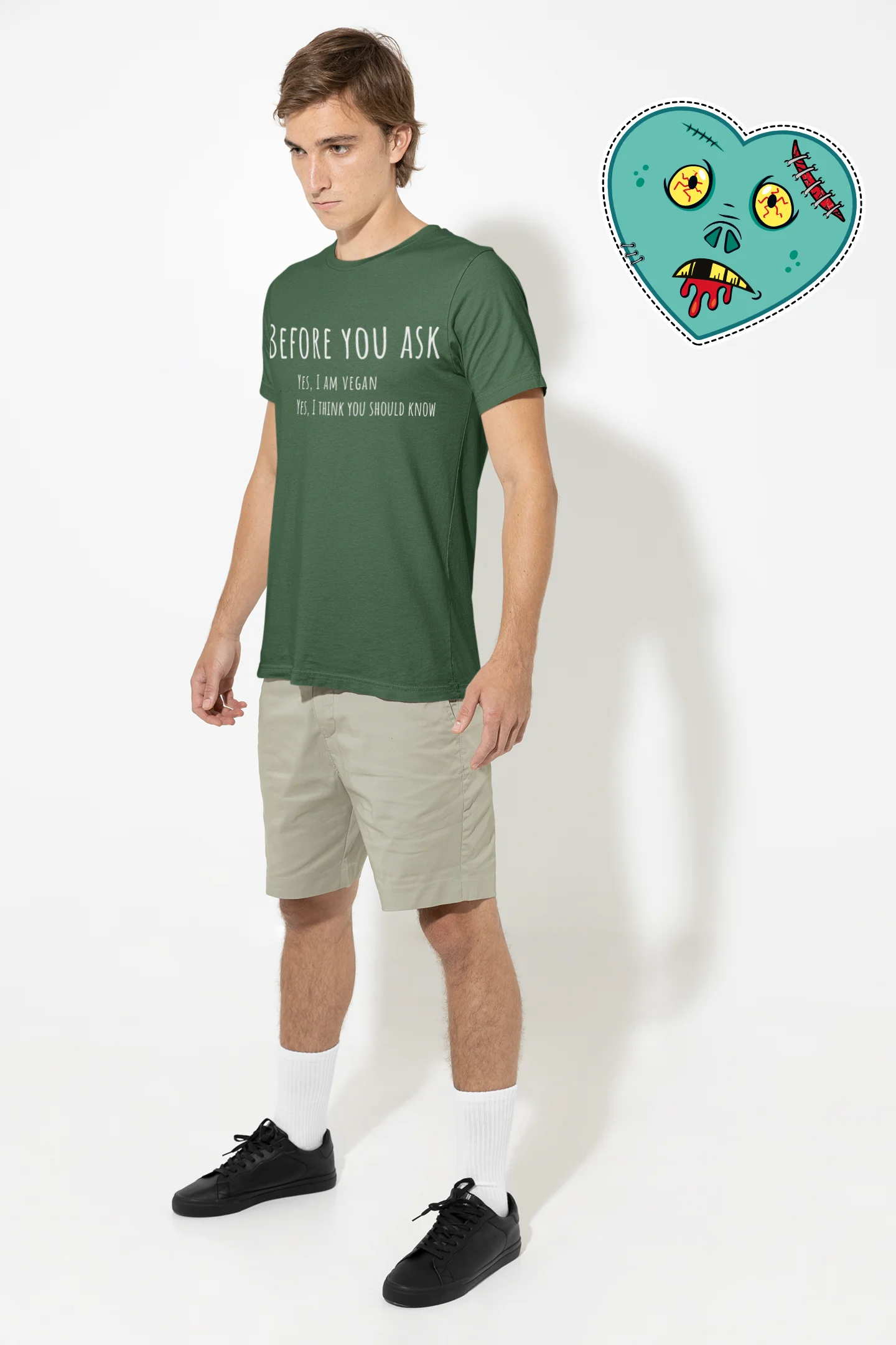 Man wearing a green t-shirt with text and beige shorts against a white background