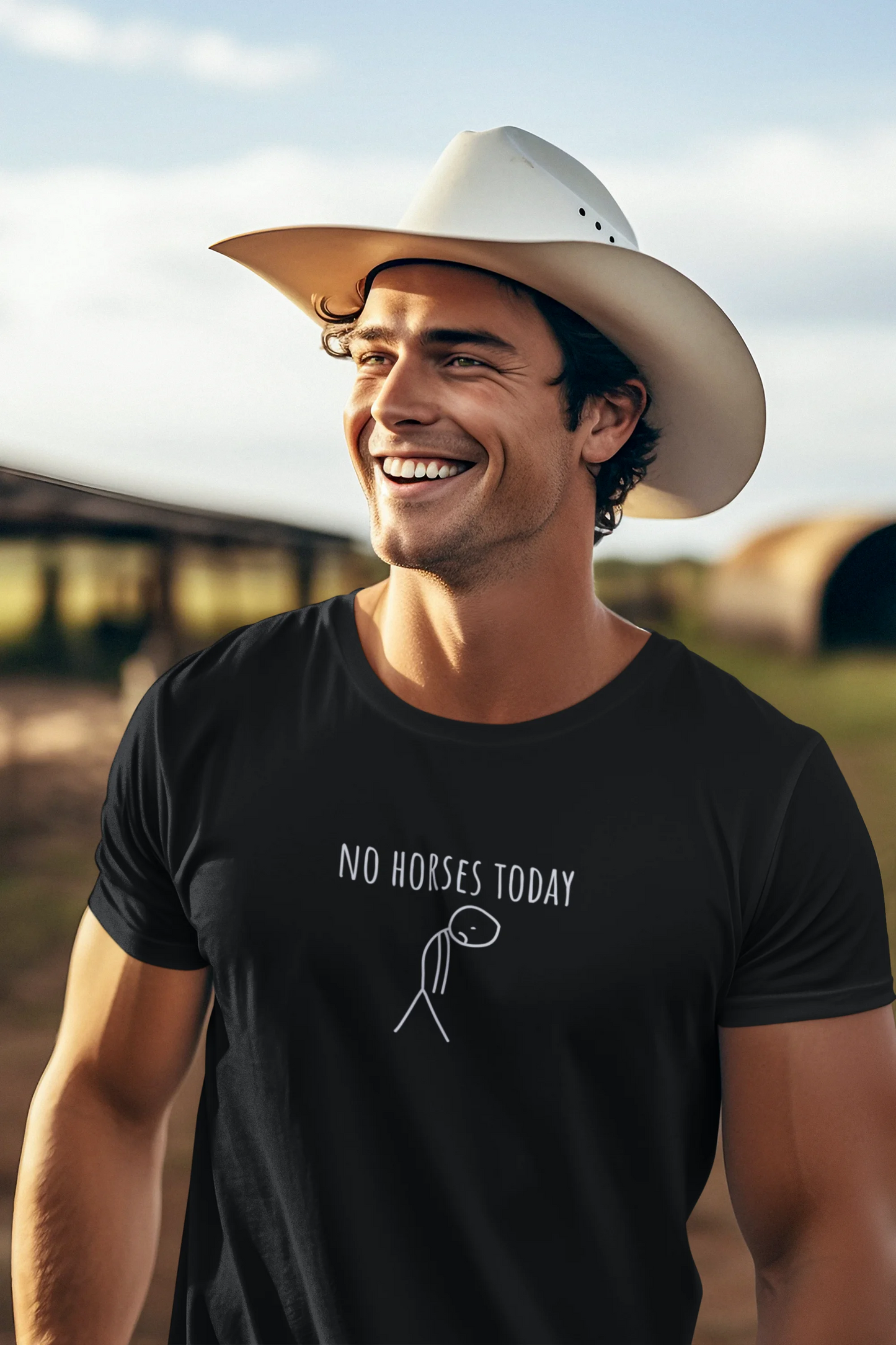 Man wearing a black t-shirt with 'No Horses Today' text and a cowboy hat outdoors.
