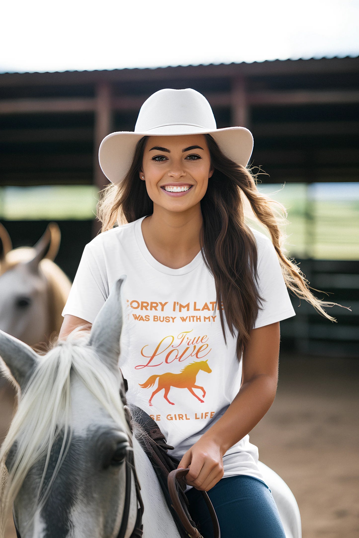 Woman riding a horse wearing a white t-shirt with a graphic and text.