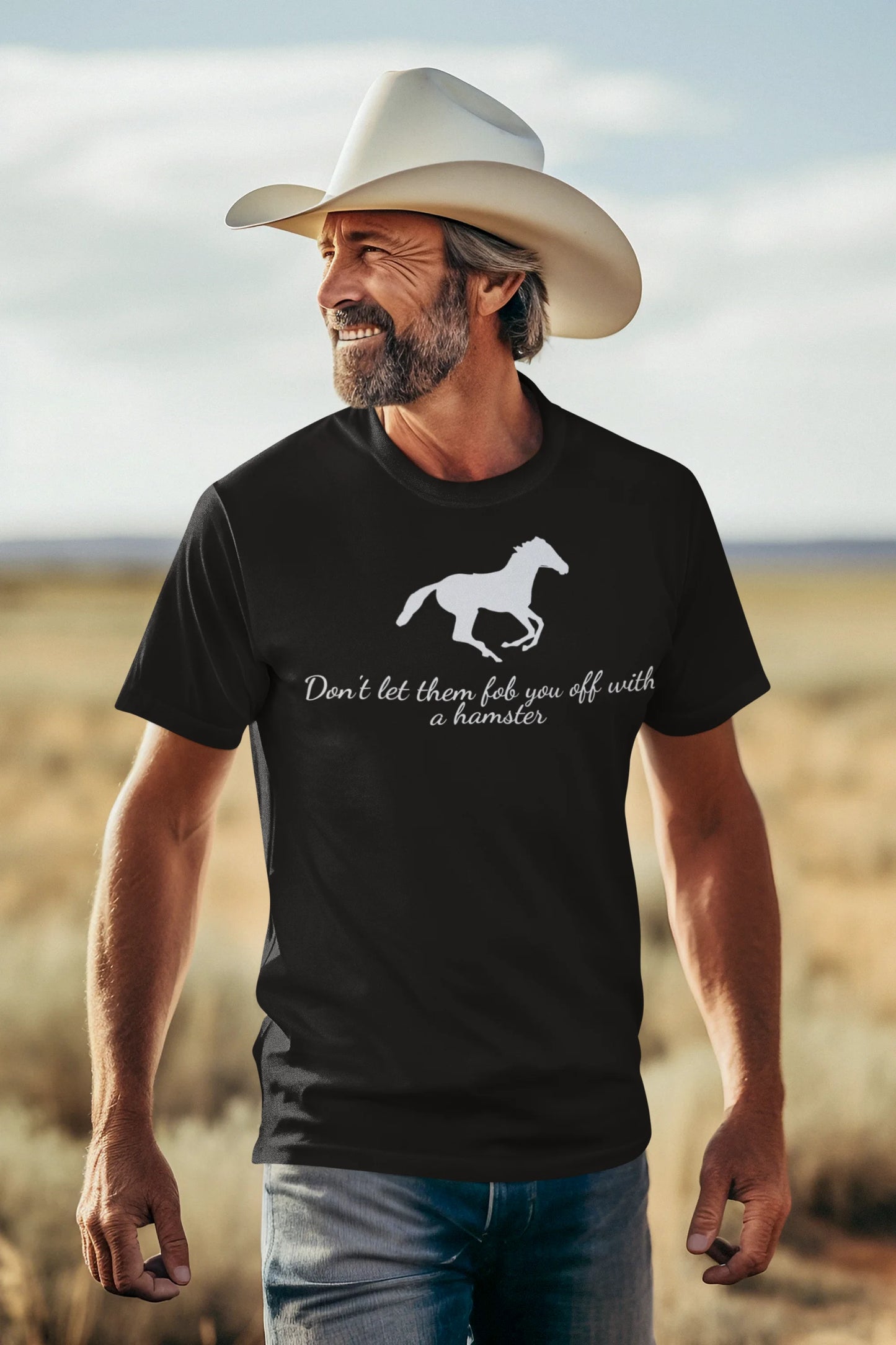 Equestrian Tee Man wearing a black t-shirt with a horse graphic and text, standing in a desert landscape.