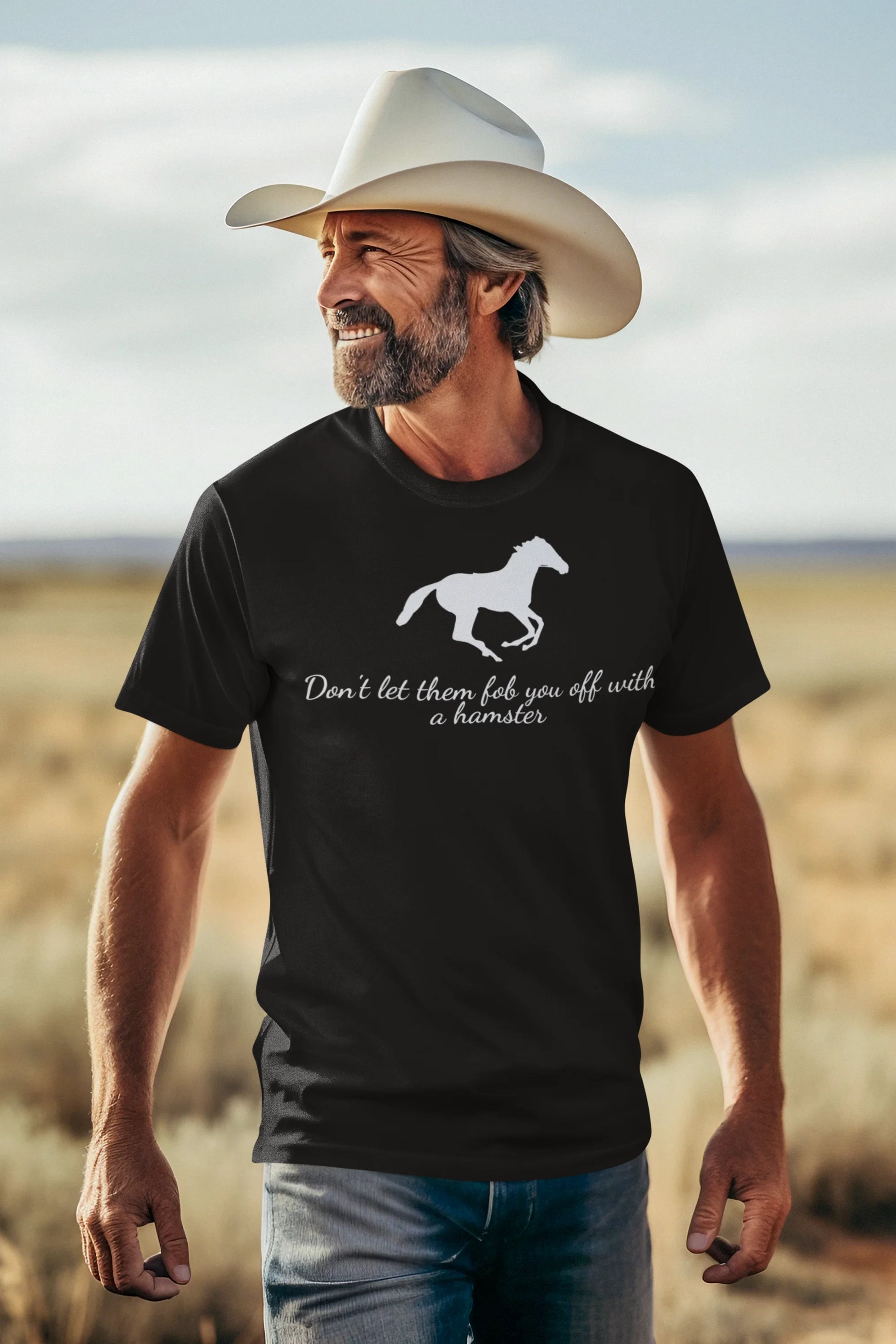 Equestrian Tee Man wearing a black t-shirt with a horse graphic and text, standing in a desert landscape.
