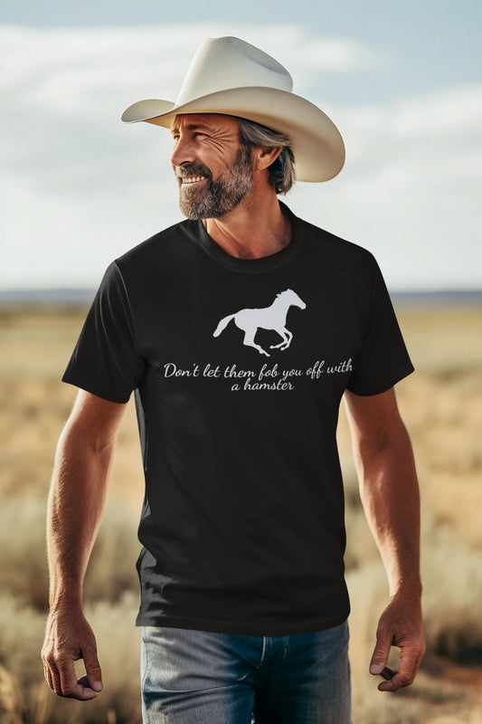 Equestrian Tee Man wearing a black t-shirt with a horse graphic and text, standing in a desert landscape.