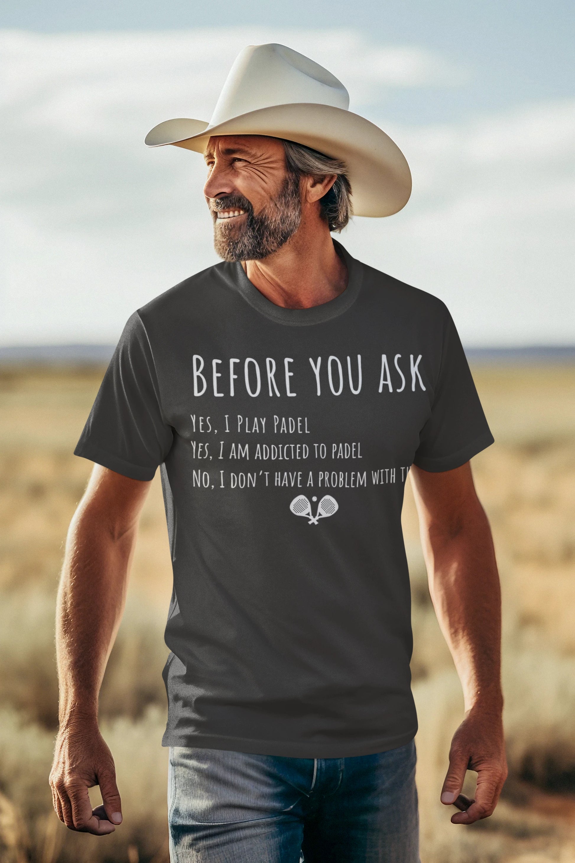 Man wearing a cowboy hat and t-shirt with text in a desert setting