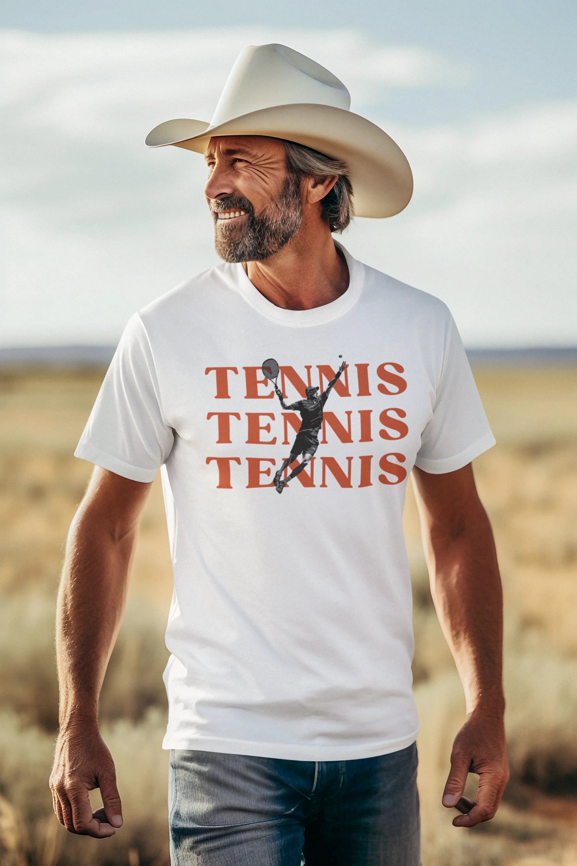 Man wearing a white t-shirt with 'TENNIS TENNIS TENNIS' and a graphic of a tennis player, standing in a desert landscape.