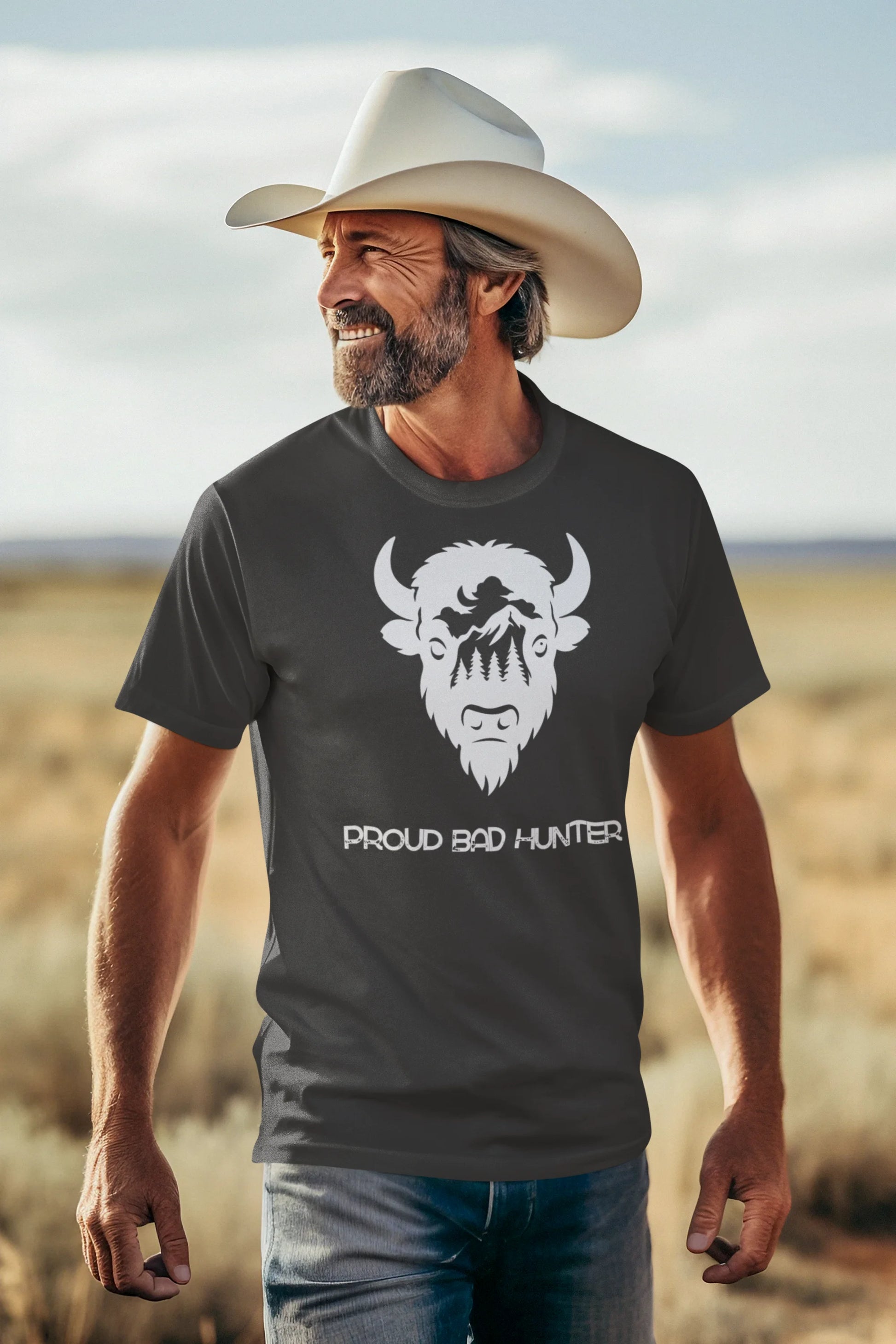 Man wearing a t-shirt with a graphic design and text, standing in a desert landscape.