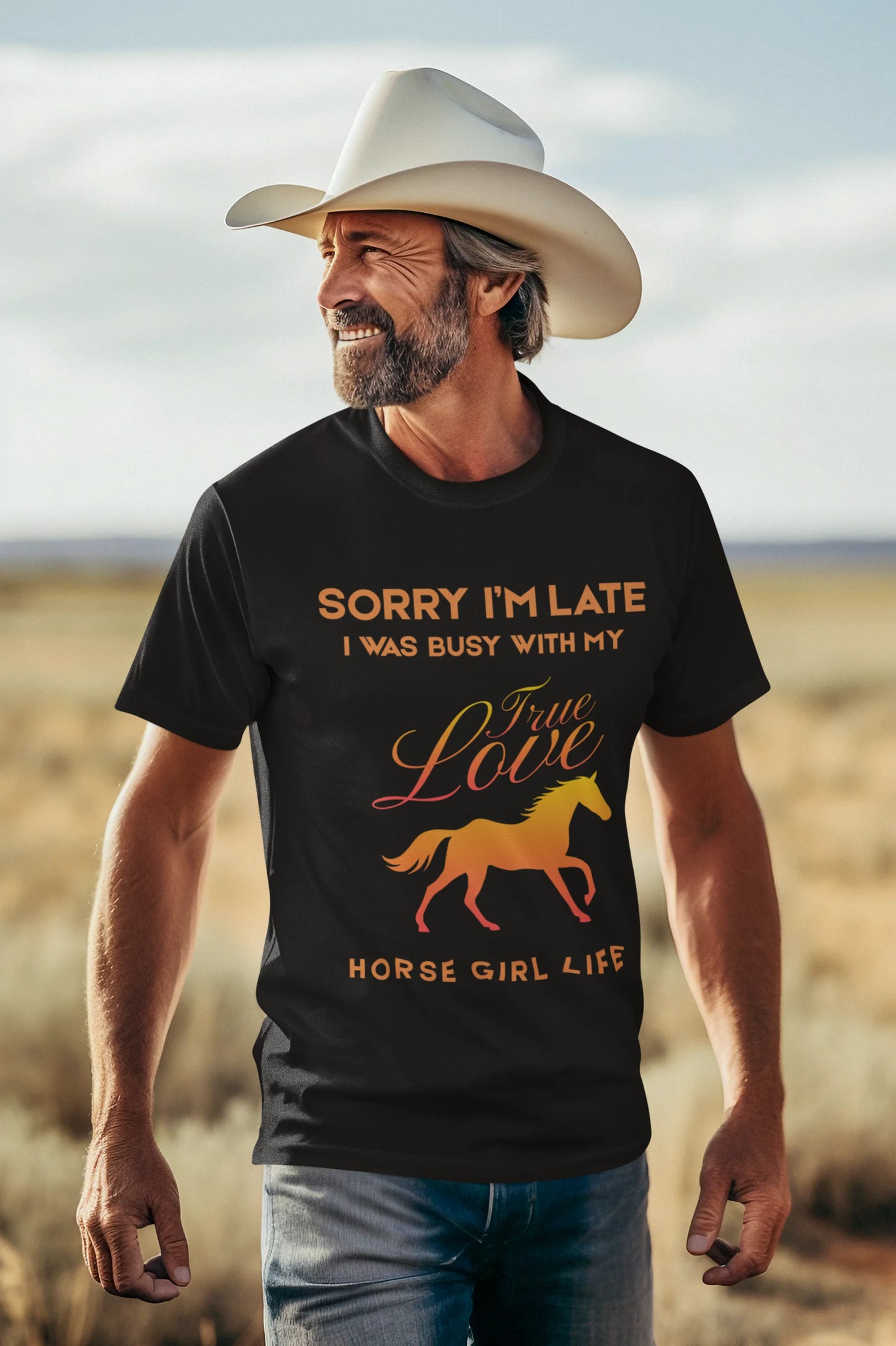 Man wearing a black t-shirt with a horse graphic and text in a desert setting