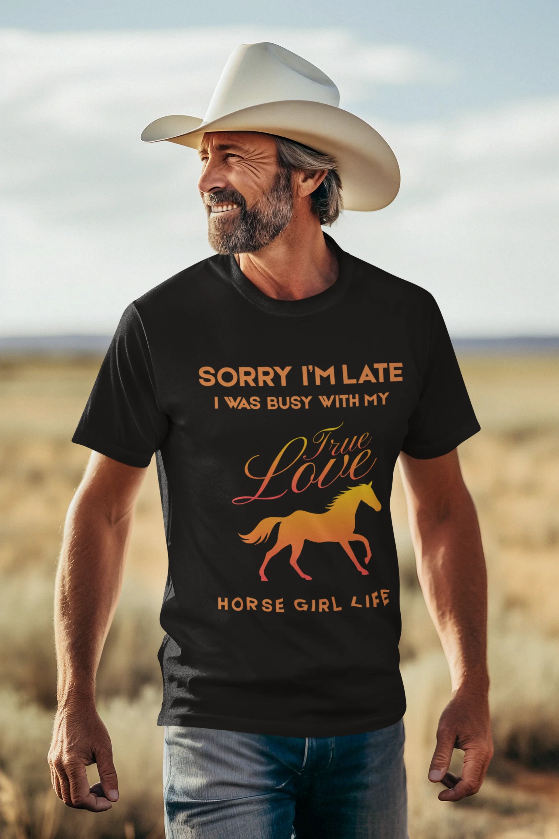 Man wearing a black t-shirt with a horse graphic and text in a desert setting