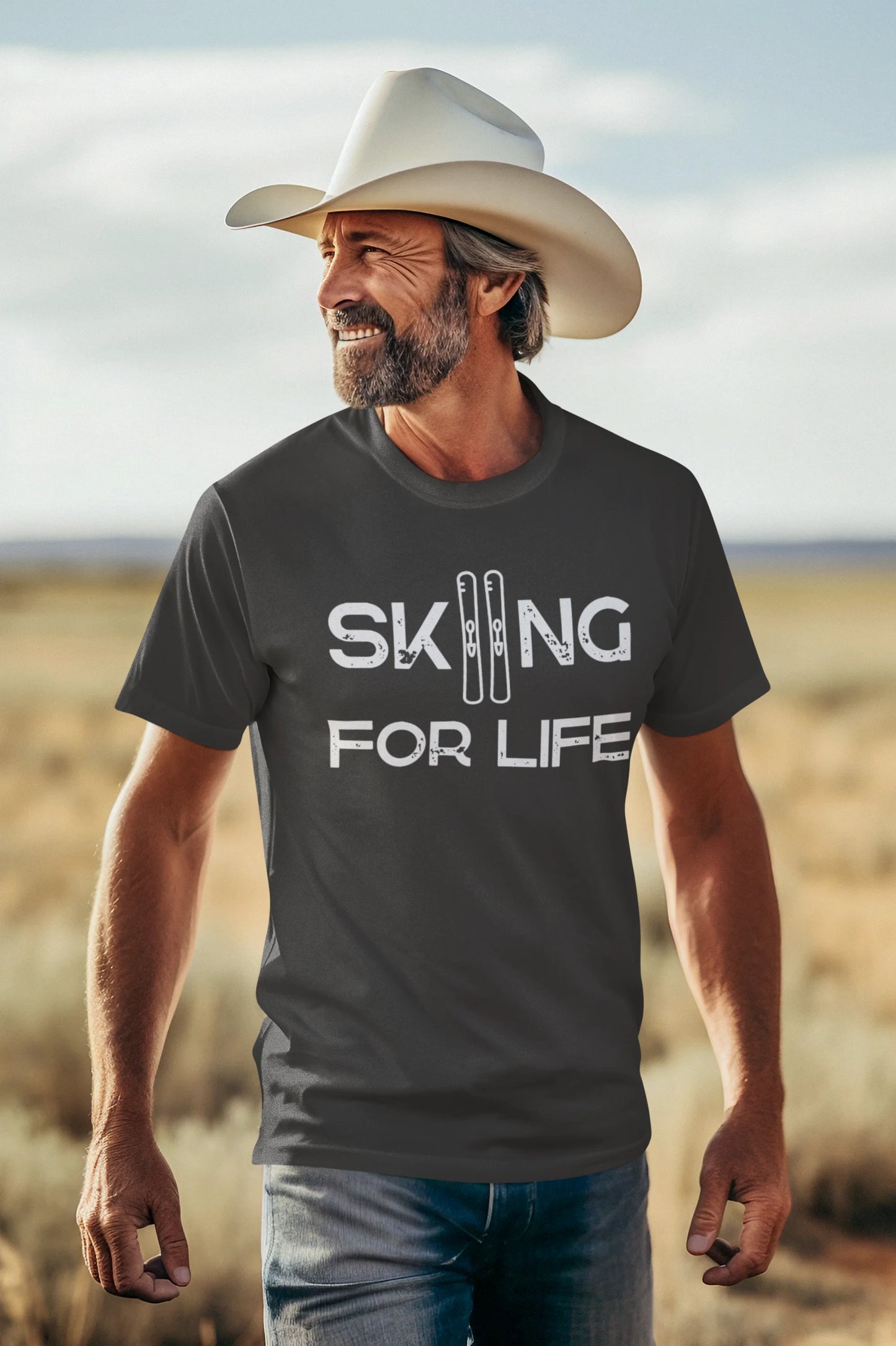 Man wearing a t-shirt with 'Skiing for Life' text in a desert setting
